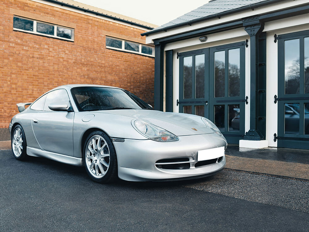 Silver sports car parked near a building.