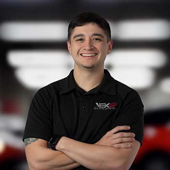 Smiling man in black polo shirt.