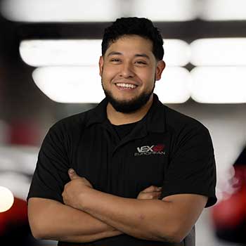 Smiling man in branded black shirt.